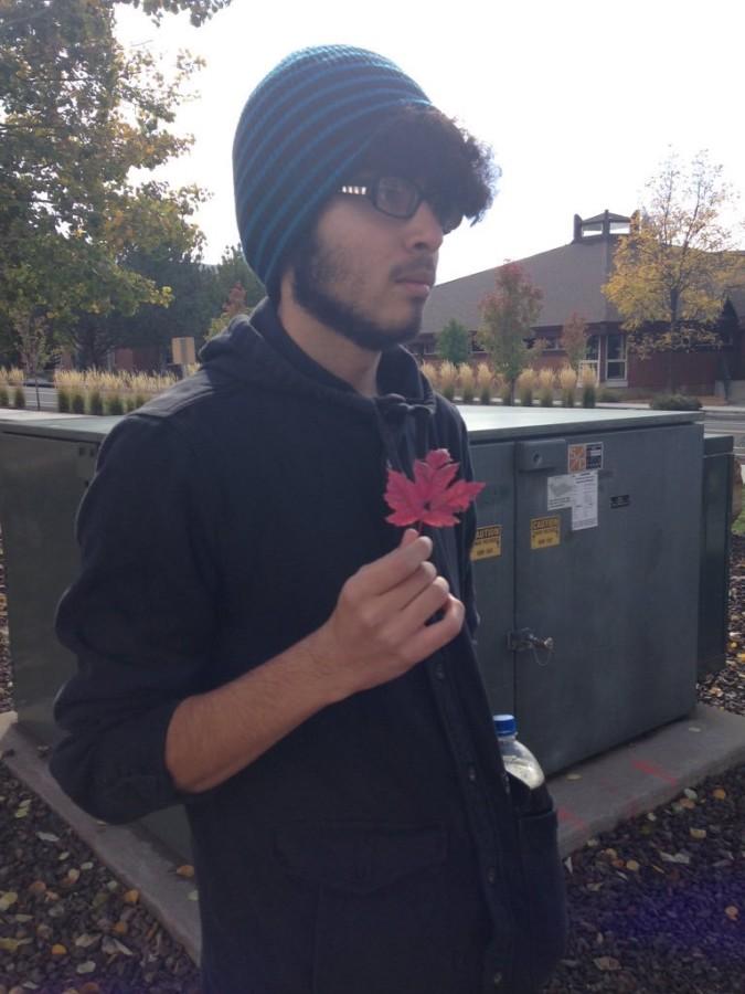 Jason Salcido showing of one of the many leaves fallen from NAU's trees.