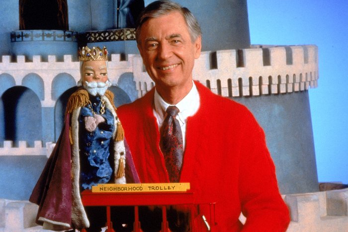 Portrait of children's television personality Fred Rogers (1928 - 2003) smiling while posing with a toy trolley on the set of his television show 'Mister Rogers' Neighborhood,' circa 1980s.  (Photo by Fotos International/Courtesy of Getty Images)