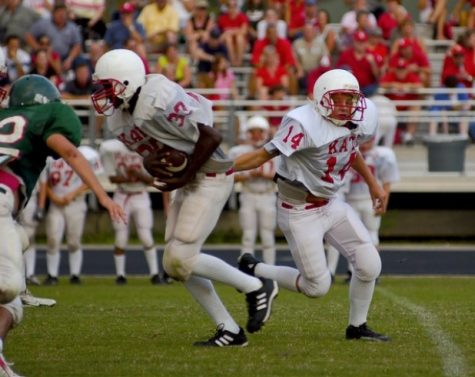 Football player running a play