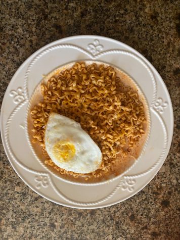 A plate of fresh made Samyang Noodles with a fried egg and cheese.