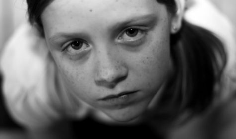 Black & white photo of a girl being sad.