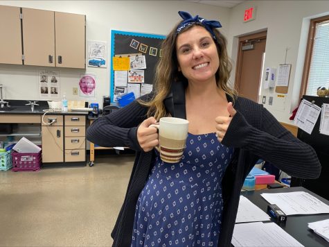 Ms. Malmos holding her coffee cup during an interview