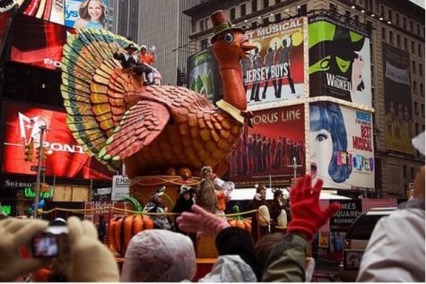 A big turkey float for thanksgiving with people surrounding it
