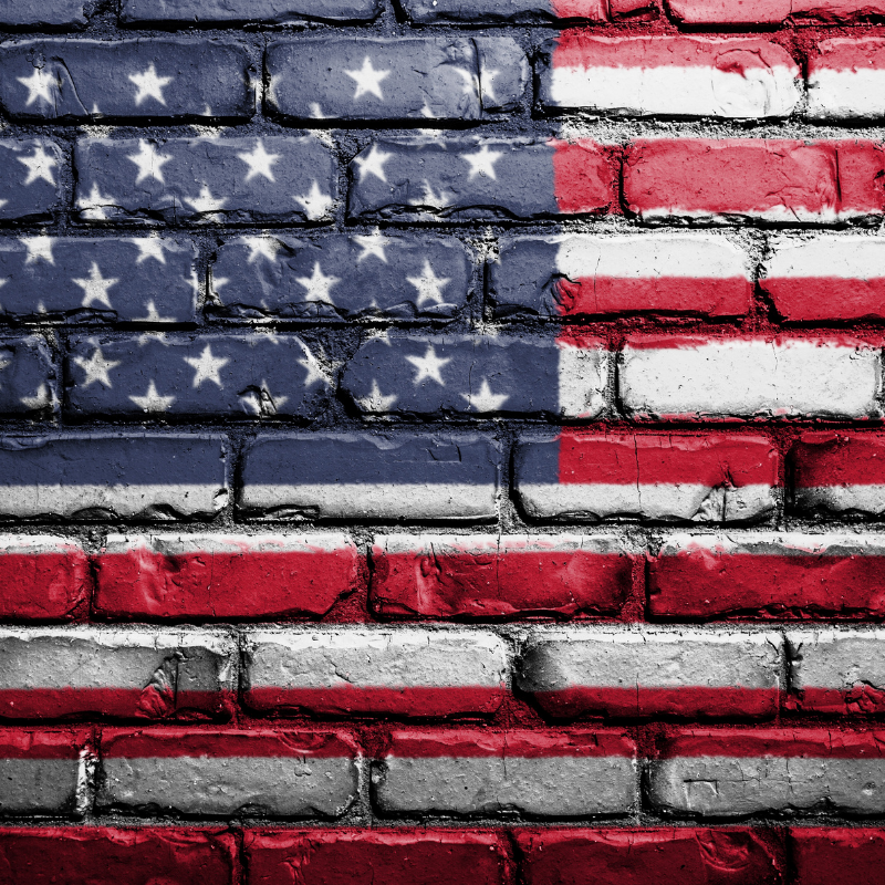 American Flag painted on brick wall.