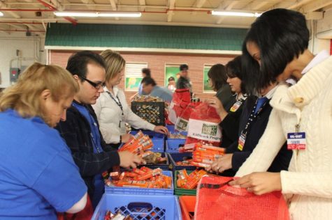 People putting together food packages for people