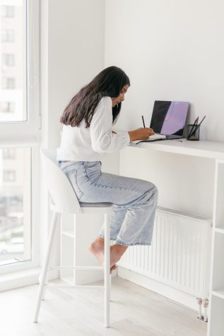 A girl sitting down studying.